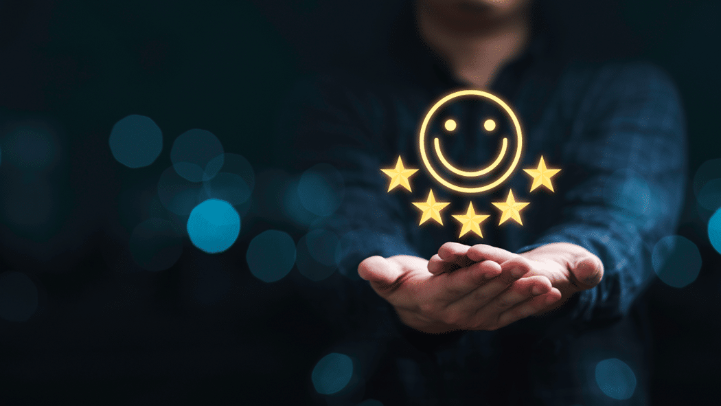 Person holding out hands with glow smiley face with stars